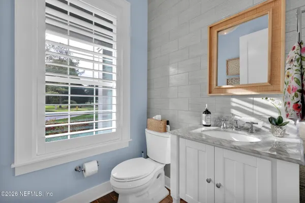 a bathroom with a sink vanity and mirror