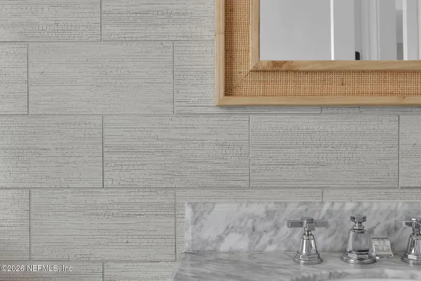 a bathroom with a sink a mirror and a window