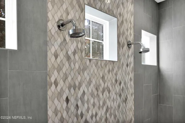 a bathroom with a granite countertop sink and a toilet