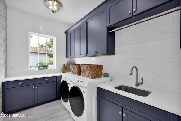 a bedroom with a bed and painting on the wall