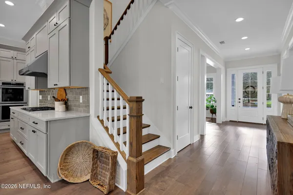 a bedroom with a bed chair and a large window