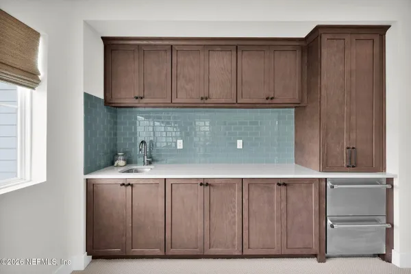 a view of a house with swimming pool and sitting area