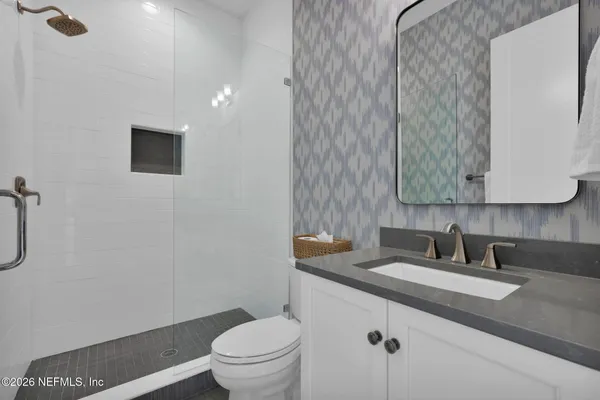 an aerial view of a house with swimming pool and outdoor seating