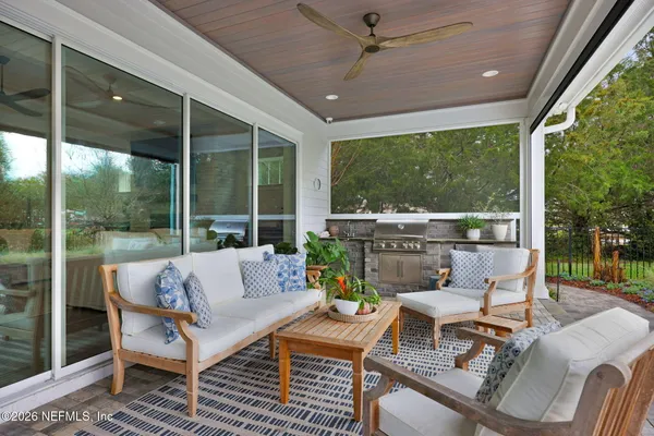 a view of a street with a bench and trees around