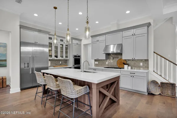 a kitchen with refrigerator cabinets dining table and chairs