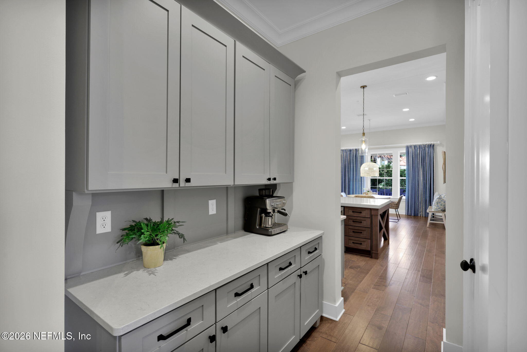 14303 Cottage Lake Road Jacksonville, FL 32224 - Photo 10 of 72 a kitchen with stainless steel appliances white cabinets and wooden floor