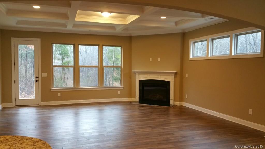 8009 Clems Branch Road Indian Land, SC 29707 - Photo 4 of 11 a view of an empty room with wooden floor and a window