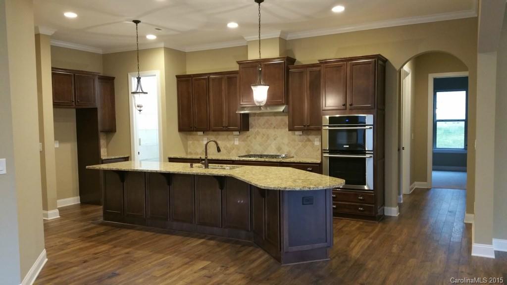 8009 Clems Branch Road Indian Land, SC 29707 - Photo 5 of 11 a kitchen with stainless steel appliances granite countertop a refrigerator a sink and a stove