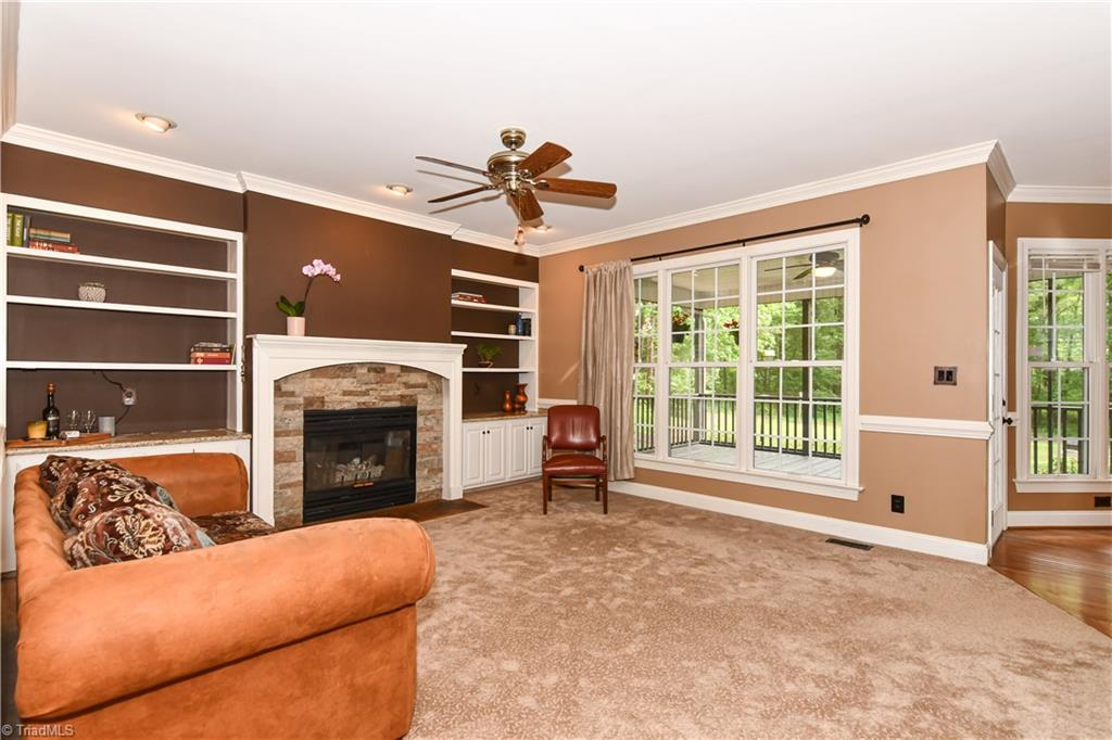 8305 Case Ridge Drive Oak Ridge, NC 27310 - Photo 14 of 48 Cozy den with recent carpet, builtins, fireplace surround and paint. A great area for families to gather.