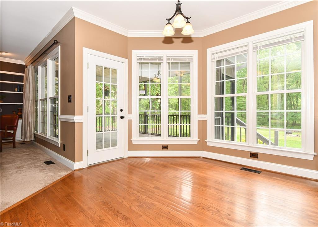 8305 Case Ridge Drive Oak Ridge, NC 27310 - Photo 22 of 48 Breakfast room overlooks the backyard and enclosed 3 Seasons Room.