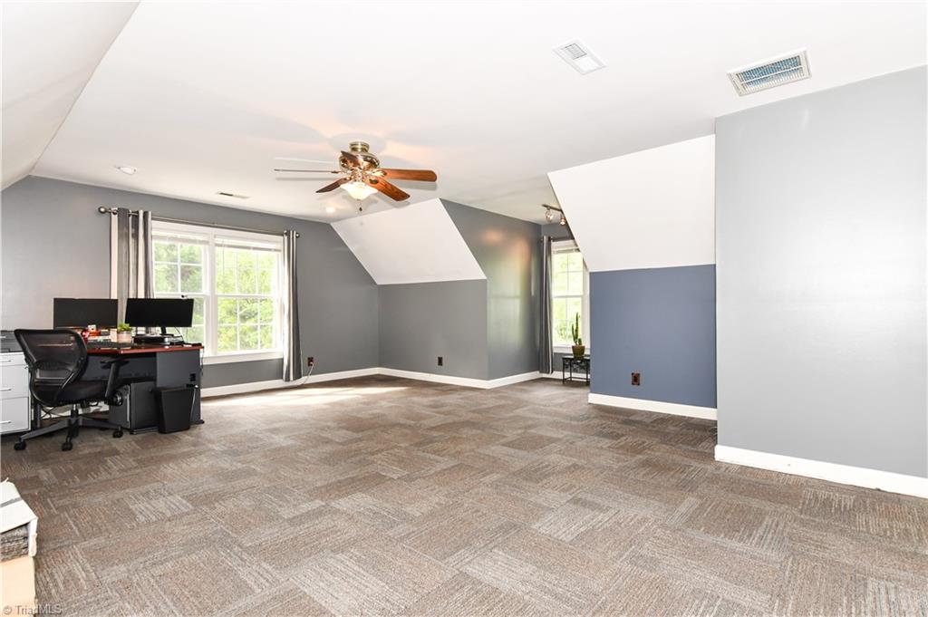 8305 Case Ridge Drive Oak Ridge, NC 27310 - Photo 40 of 48 Large and open bonus could be bedroom 4, or office/playroom/gameroom. Great flooring and neutral colors are an added feature.
