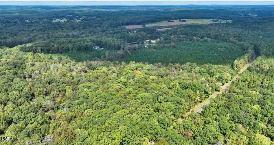 8635 Johnson Mill Road Bahama, NC 27503 - Photo 2 of 5 a view of a green field with lots of bushes
