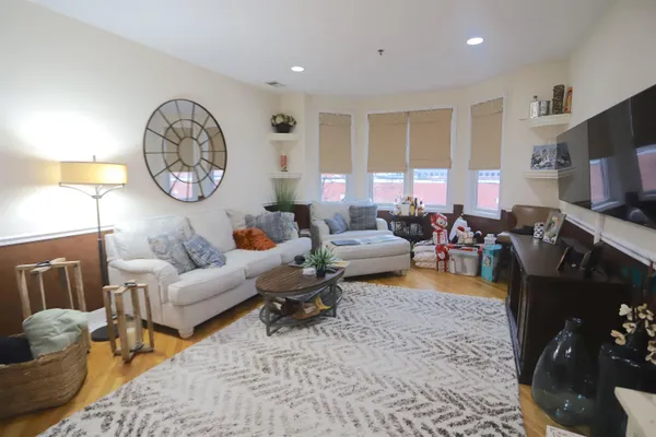 a living room with furniture a window and a clock