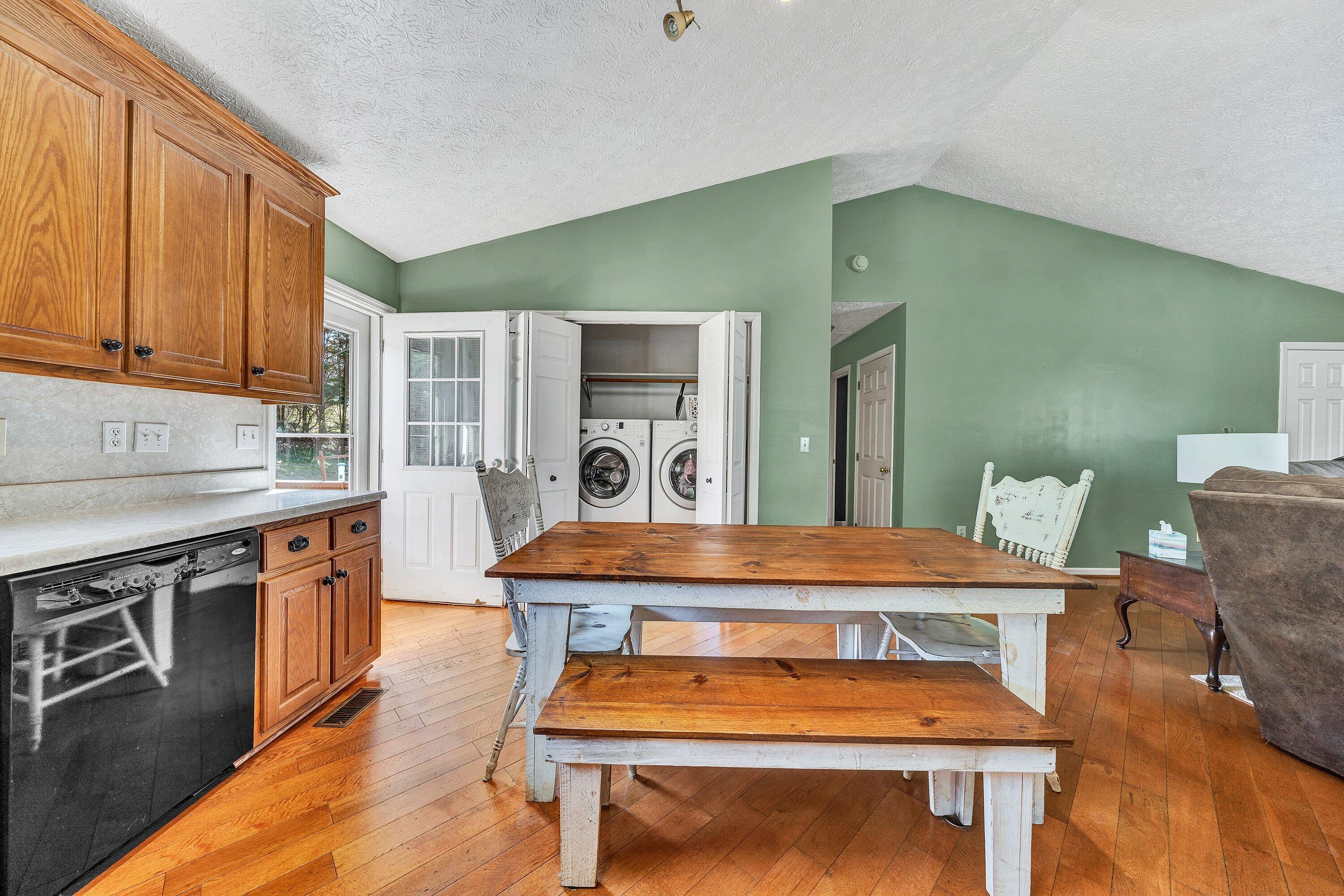 12614 Henry Road Henry, VA 24102 - Photo 11 of 34 a dining room with a table chairs and a kitchen view