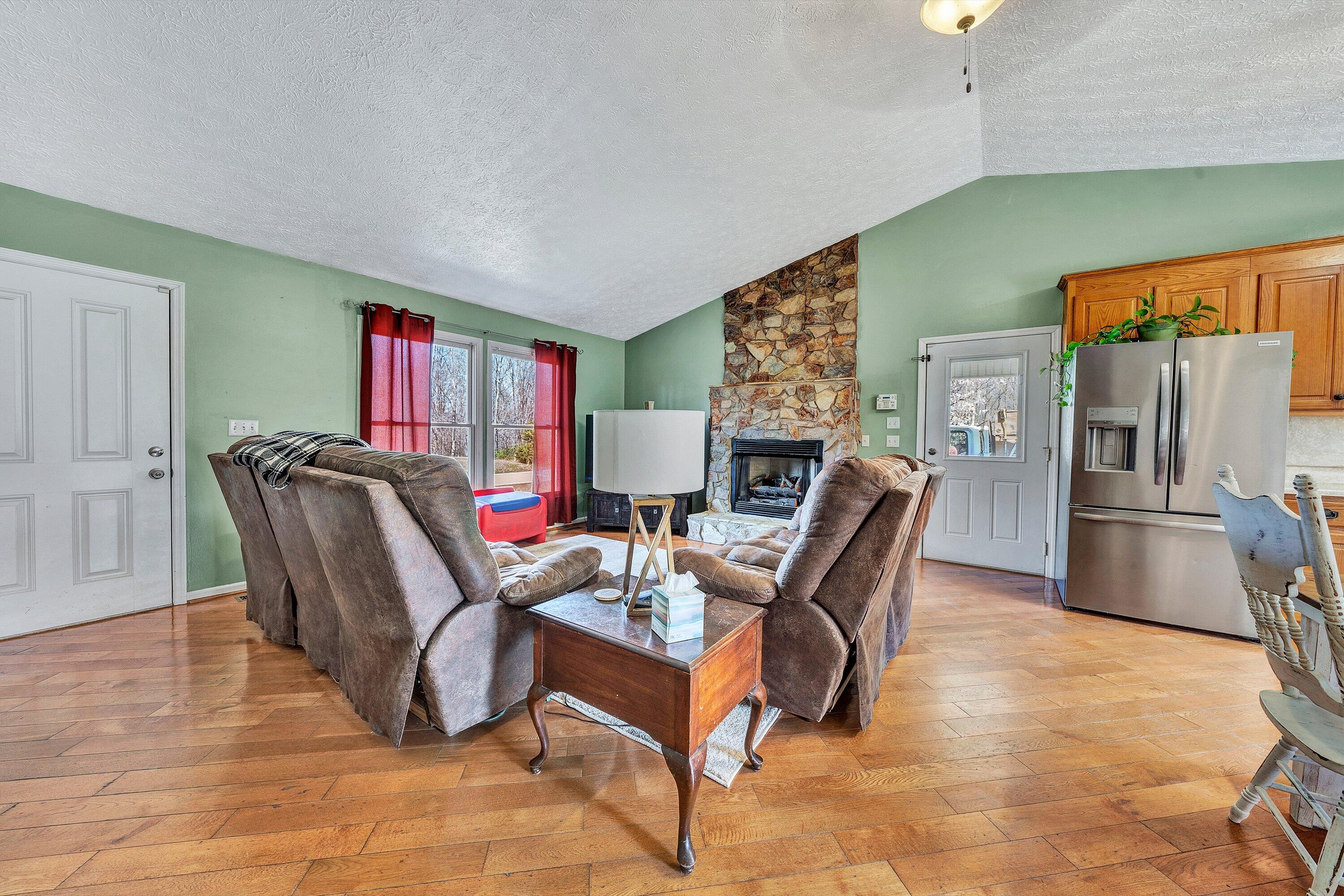 12614 Henry Road Henry, VA 24102 - Photo 3 of 34 a living room with furniture and a kitchen