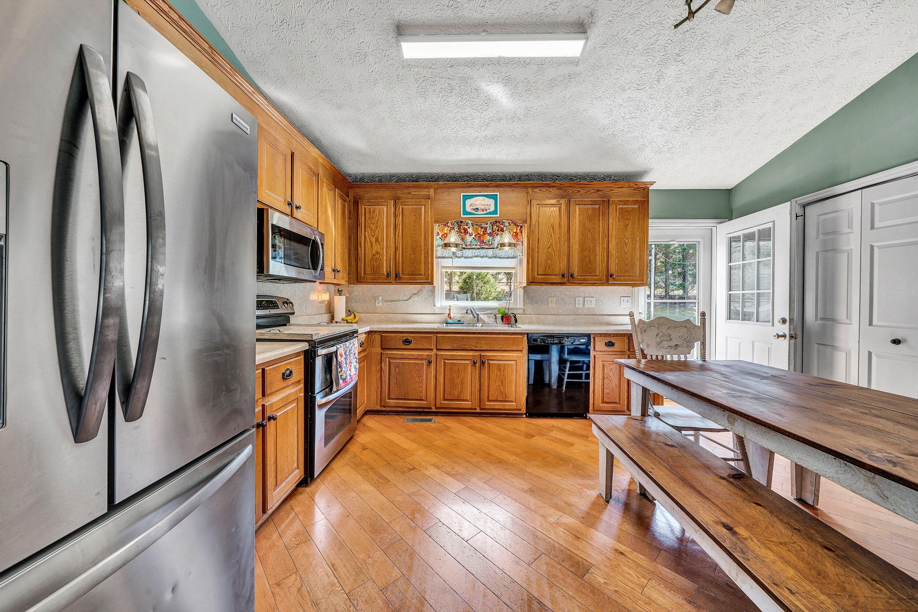 12614 Henry Road Henry, VA 24102 - Photo 8 of 34 a kitchen with stainless steel appliances granite countertop a refrigerator a stove and a sink