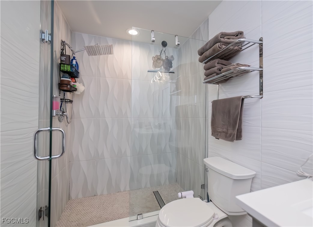 8513 Bernwood Cove Loop, Unit 212 Fort Myers, FL 33966 - Photo 19 of 43 a bathroom with a toilet and a shower