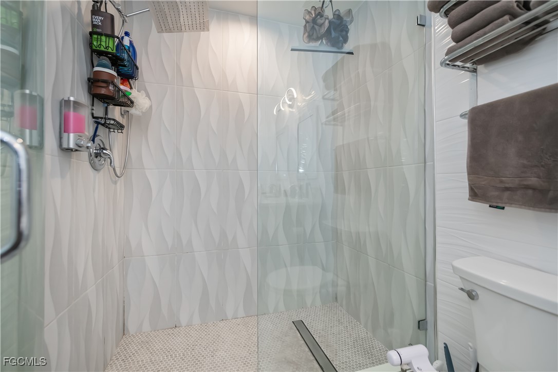 8513 Bernwood Cove Loop, Unit 212 Fort Myers, FL 33966 - Photo 20 of 43 a bathroom with a shower and a toilet