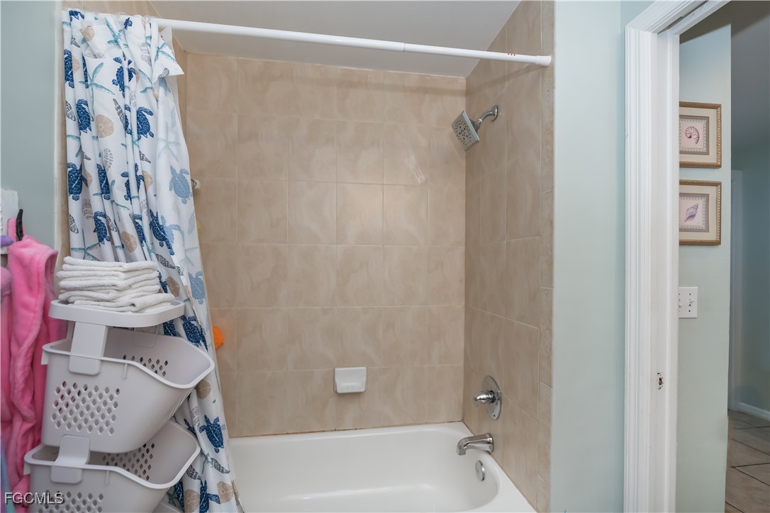 8513 Bernwood Cove Loop, Unit 212 Fort Myers, FL 33966 - Photo 24 of 43 a bathroom with a bathtub and shower