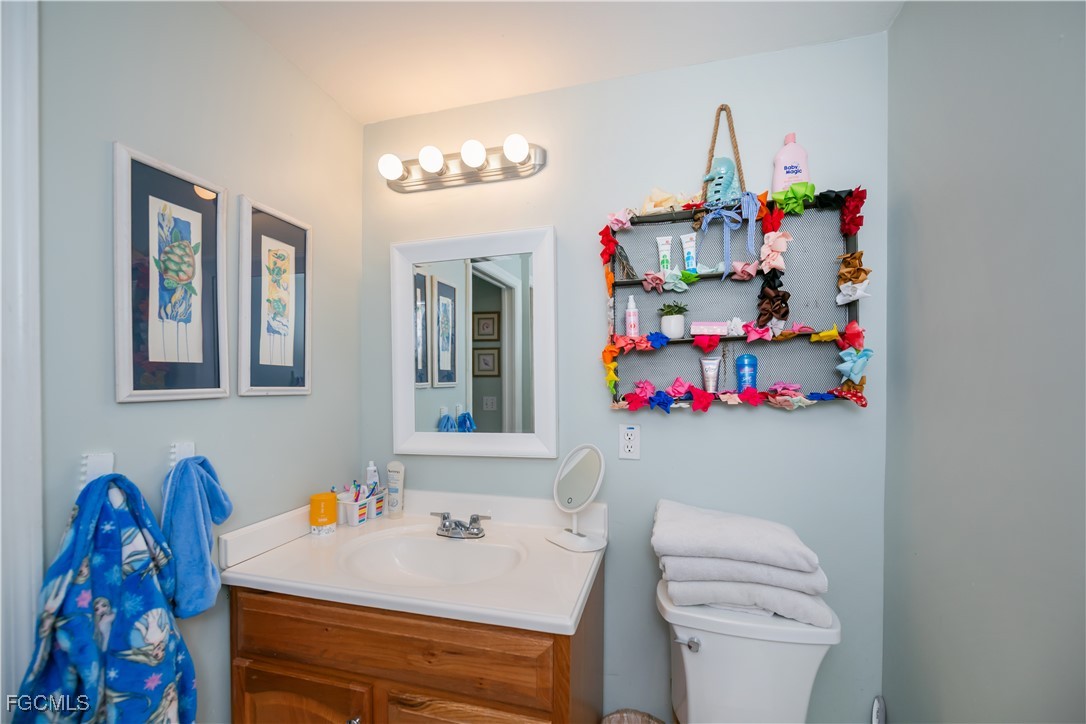 8513 Bernwood Cove Loop, Unit 212 Fort Myers, FL 33966 - Photo 25 of 43 a bathroom with a sink a vanity and a mirror