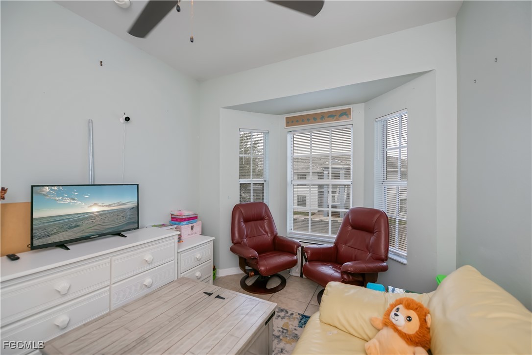 8513 Bernwood Cove Loop, Unit 212 Fort Myers, FL 33966 - Photo 28 of 43 a living room with furniture and a flat screen tv