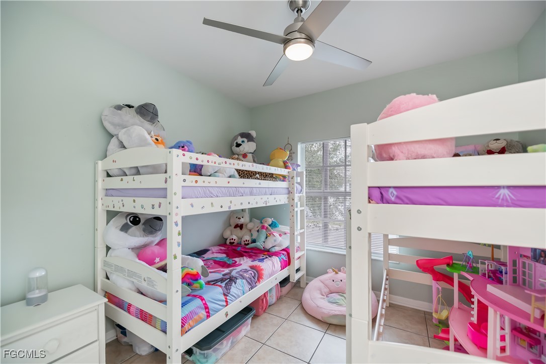 8513 Bernwood Cove Loop, Unit 212 Fort Myers, FL 33966 - Photo 30 of 43 a bedroom with a bed and a couch