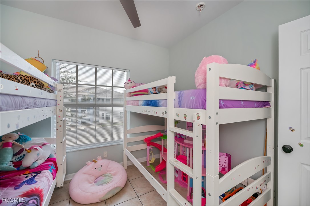 8513 Bernwood Cove Loop, Unit 212 Fort Myers, FL 33966 - Photo 31 of 43 a bedroom with baby bed and a window