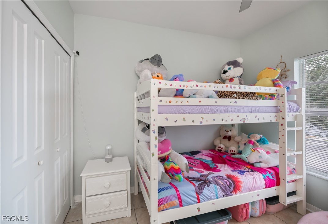 8513 Bernwood Cove Loop, Unit 212 Fort Myers, FL 33966 - Photo 32 of 43 a bedroom with a bed and a window