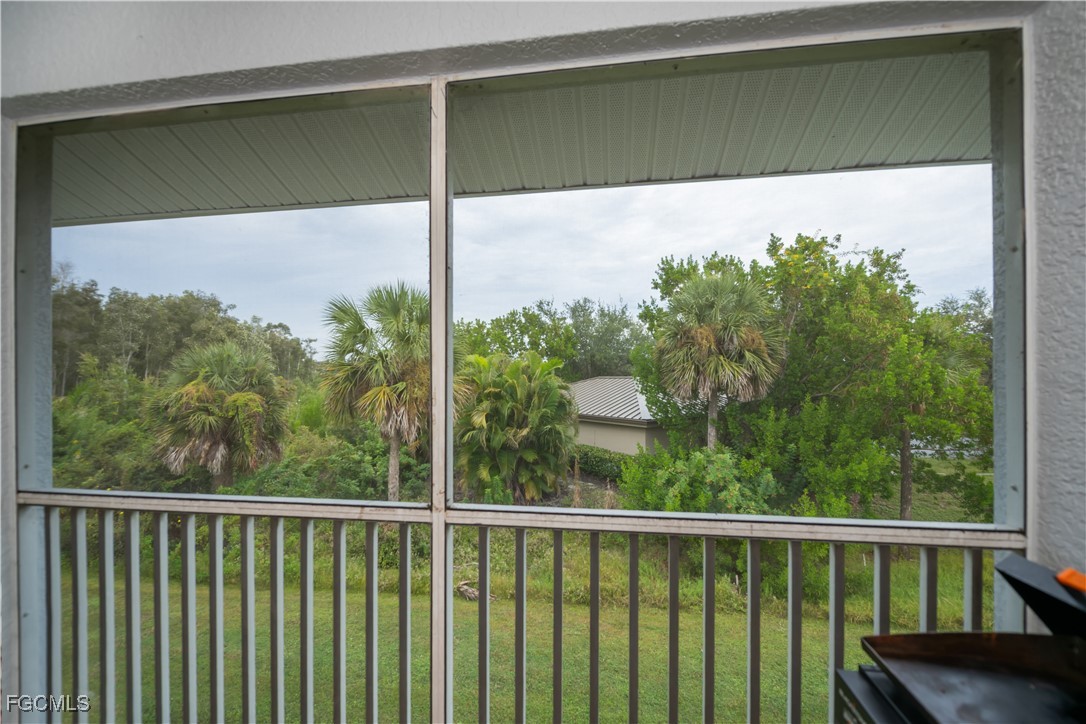 8513 Bernwood Cove Loop, Unit 212 Fort Myers, FL 33966 - Photo 34 of 43 a view of a balcony with a tree