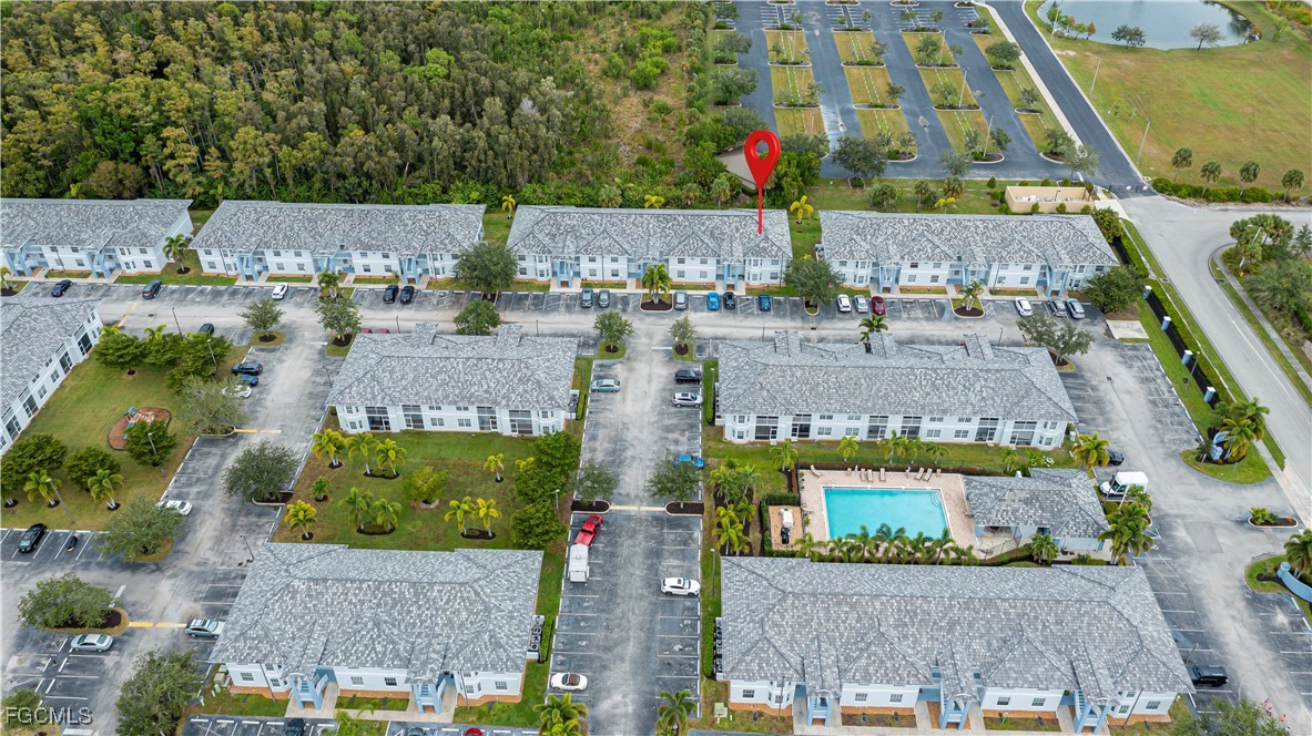 8513 Bernwood Cove Loop, Unit 212 Fort Myers, FL 33966 - Photo 37 of 43 an aerial view of houses with a yard