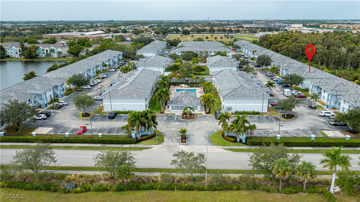 8513 Bernwood Cove Loop, Unit 212 Fort Myers, FL 33966 - Photo 38 of 43 an aerial view of residential houses with outdoor space and lake view
