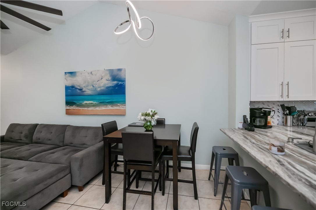 8513 Bernwood Cove Loop, Unit 212 Fort Myers, FL 33966 - Photo 7 of 43 a view of a dining room with furniture and wooden floor
