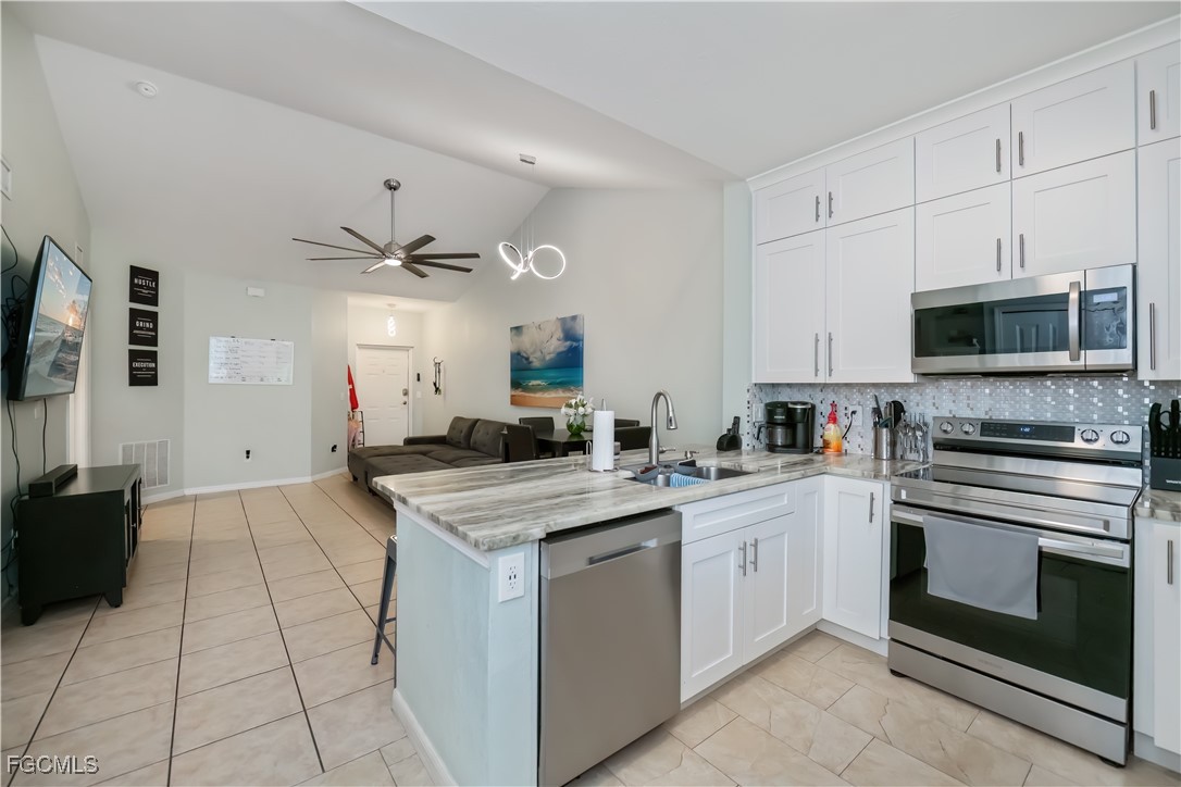 8513 Bernwood Cove Loop, Unit 212 Fort Myers, FL 33966 - Photo 10 of 43 a kitchen with a stove sink and microwave