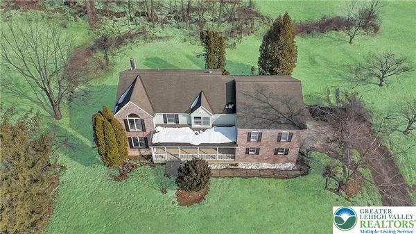 an aerial view of a house with a yard