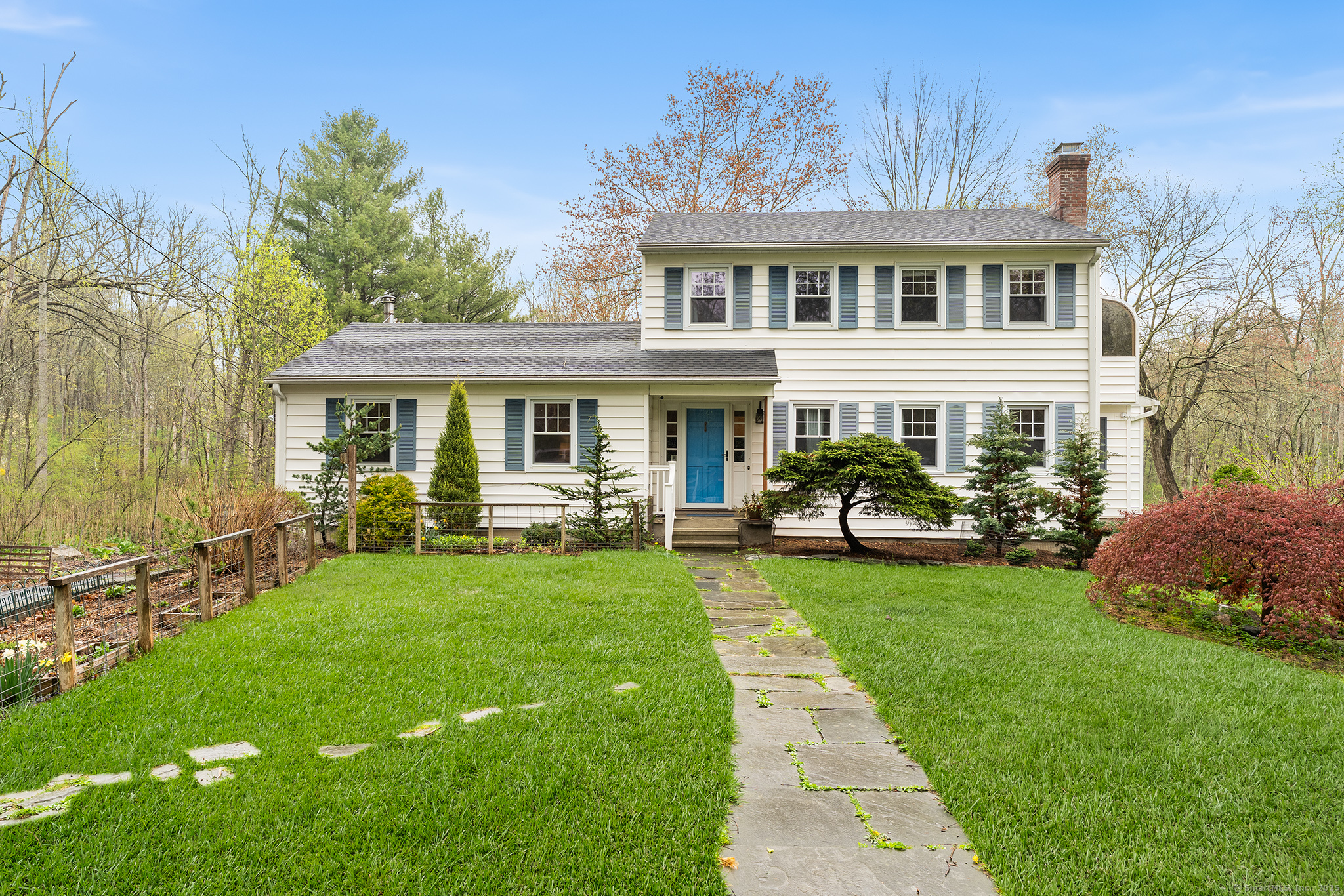 a front view of a house with a garden
