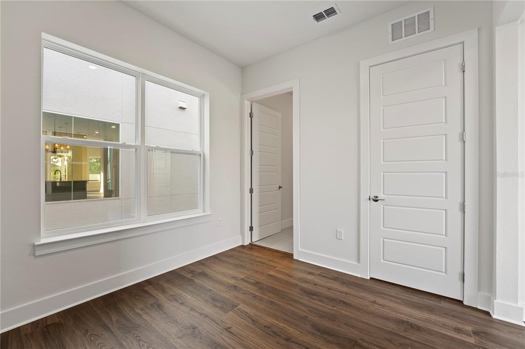 850 TETBURY Loop Oviedo, FL 32765 - Photo 12 of 24 a view of an empty room with wooden floor and a window