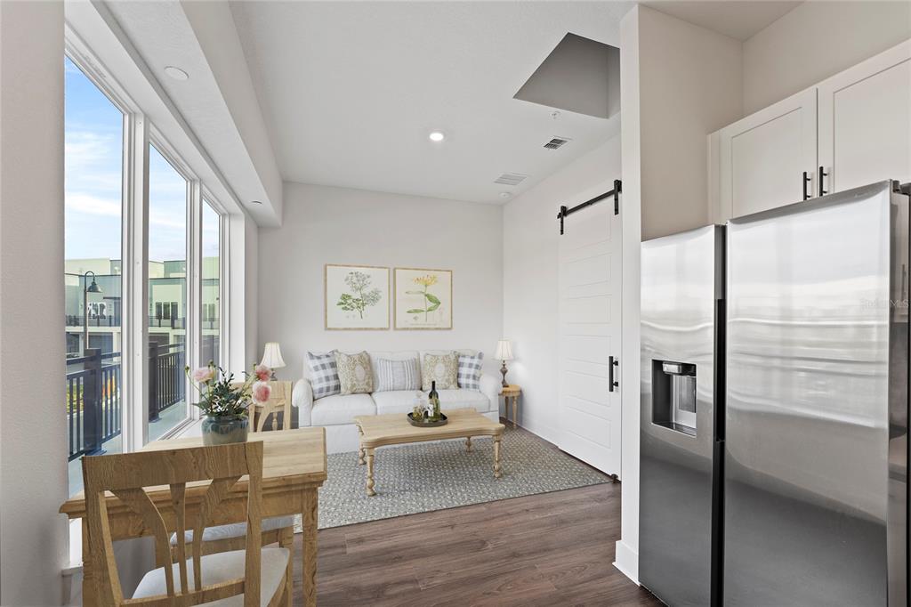 850 TETBURY Loop Oviedo, FL 32765 - Photo 5 of 24 a living room with stainless steel appliances furniture a large window and a refrigerator