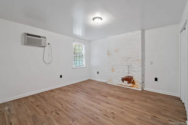 a view of a room with wooden floor and entryway