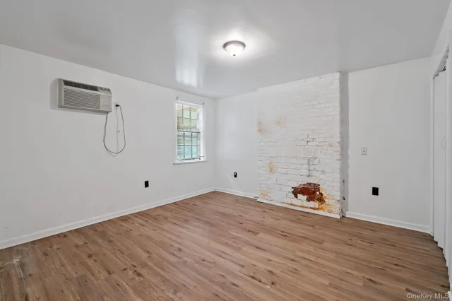 a view of a room with wooden floor and entryway