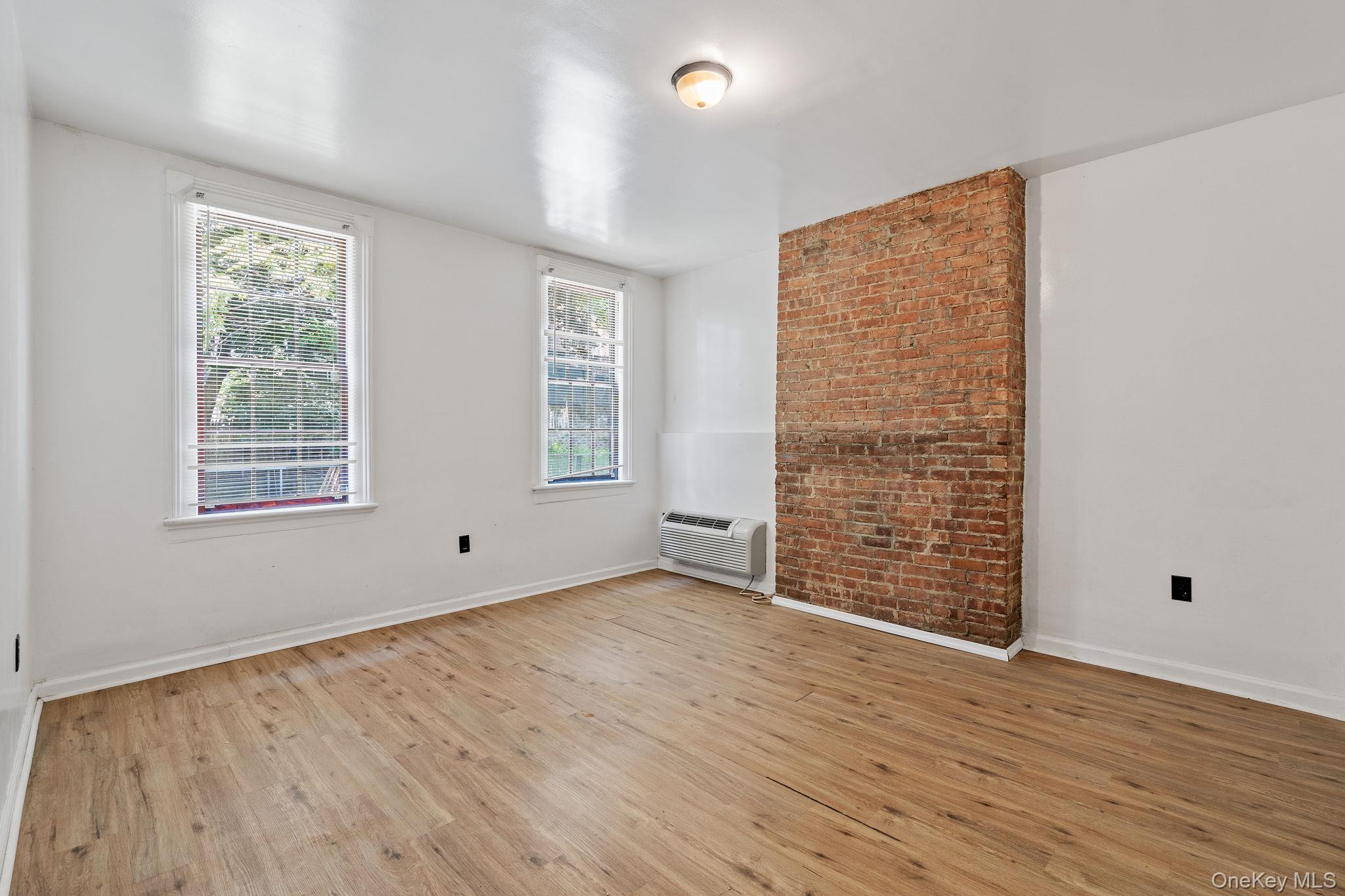 160 Lander Street Newburgh, NY 12550 - Photo 16 of 29 an empty room with wooden floor and windows
