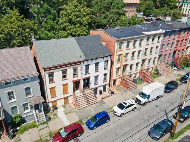 an aerial view of residential houses with outdoor space