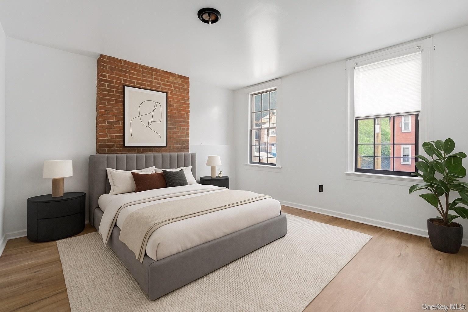 160 Lander Street Newburgh, NY 12550 - Photo 3 of 29 a bedroom with a bed and a potted plant