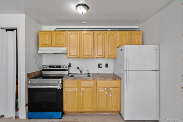 a view of a kitchen with a stove refrigerator and microwave