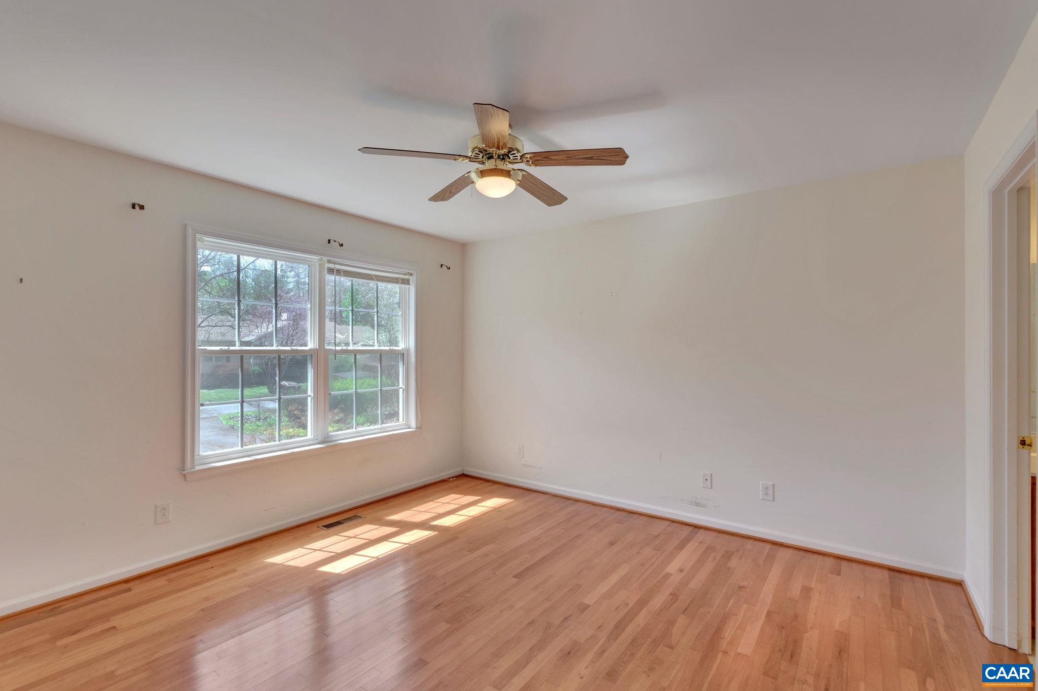 18 Loblolly Road Palmyra, VA 22963 - Photo 23 of 41 an empty room with wooden floor ceiling fan and windows