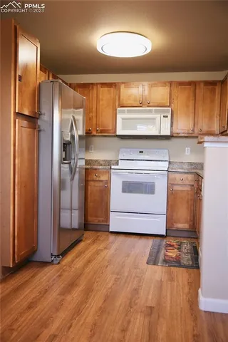 a kitchen with stainless steel appliances a refrigerator sink and cabinets
