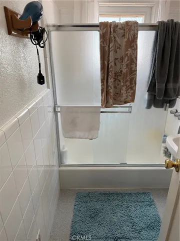 a bathroom with a shower and a window