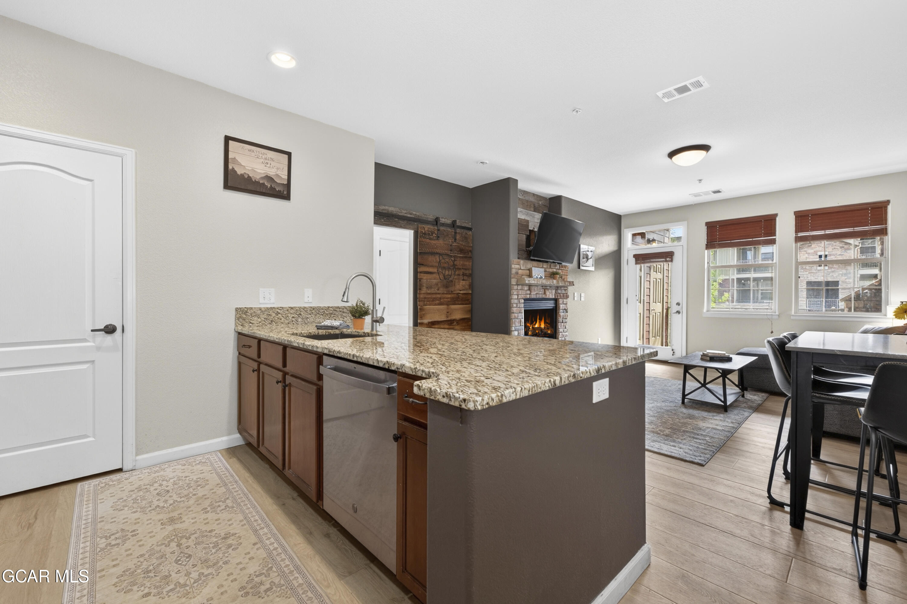 158 Village Road Granby, CO 80446 - Photo 4 of 46 a kitchen with granite countertop sink stove and dining table