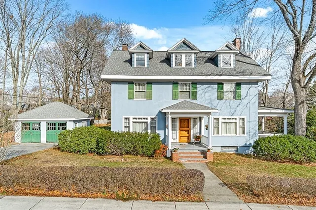 a front view of a house with yard porch and furniture