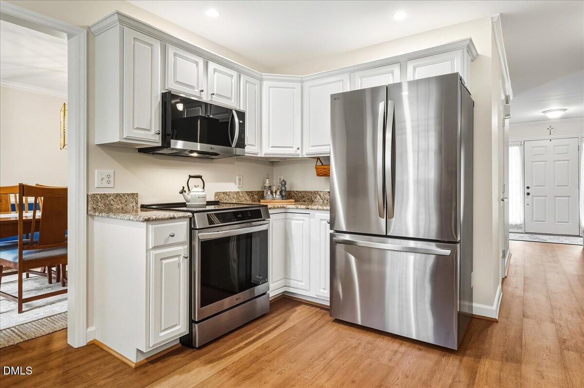 617 Rodney Bay Crossing Wake Forest, NC 27587 - Photo 14 of 36 a kitchen with stainless steel appliances a refrigerator stove and microwave
