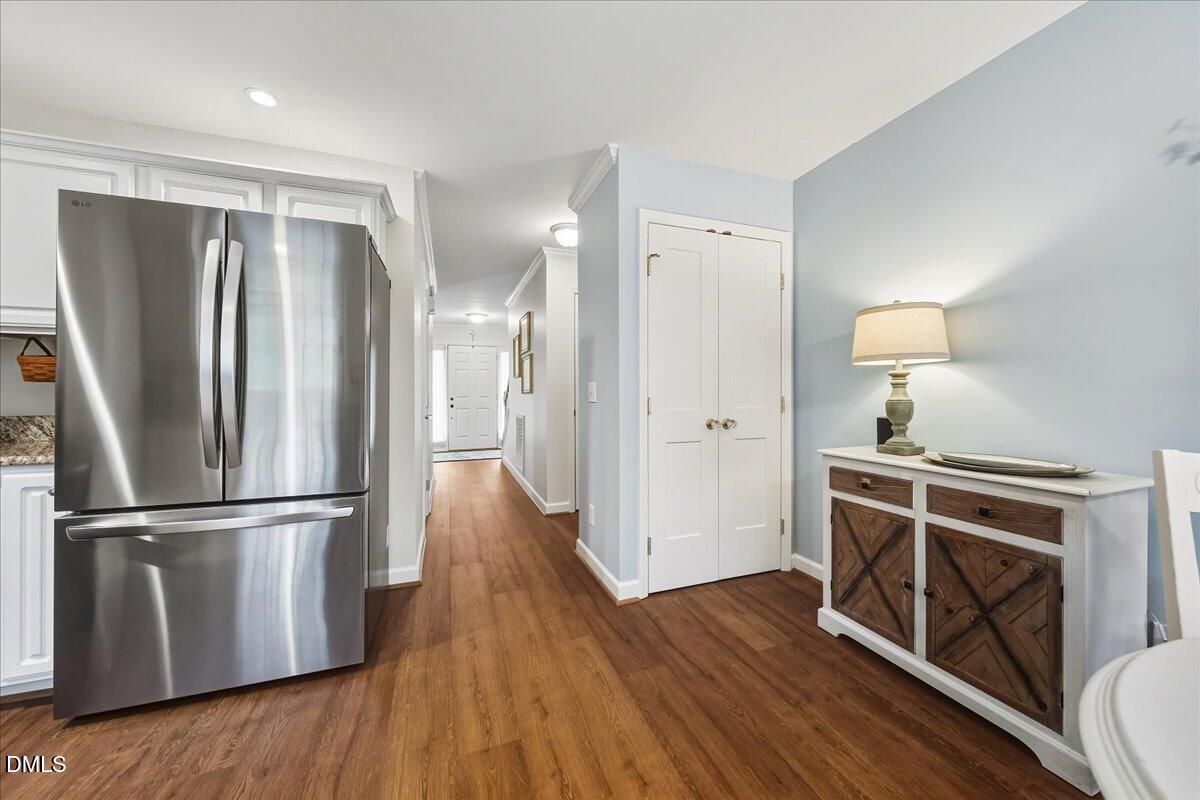 617 Rodney Bay Crossing Wake Forest, NC 27587 - Photo 15 of 36 a kitchen with wooden floors and stainless steel appliances